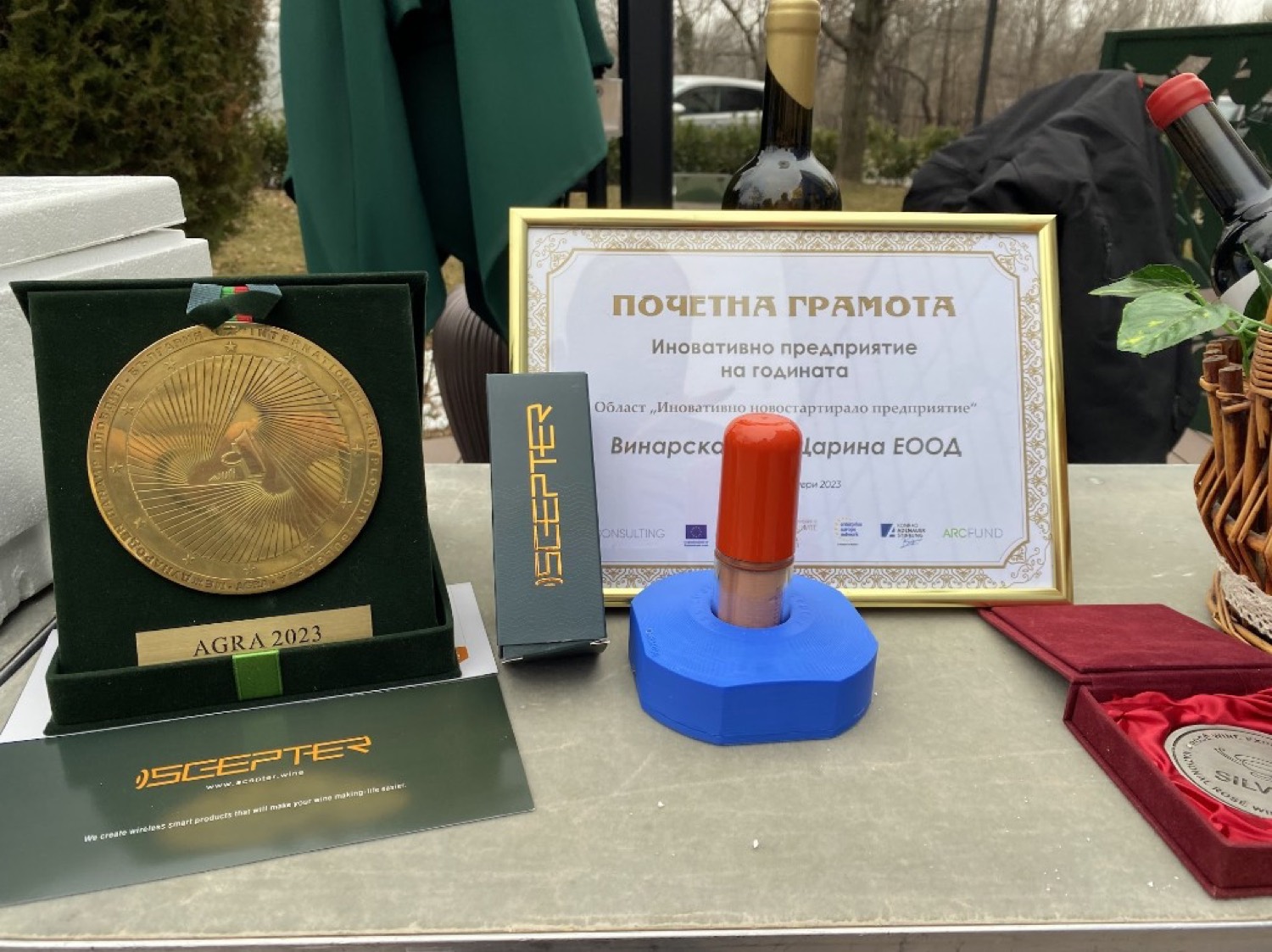 AGRA 2023 gold medal in its green case beside the honorary diploma, a SCEPTER retail box and the float device