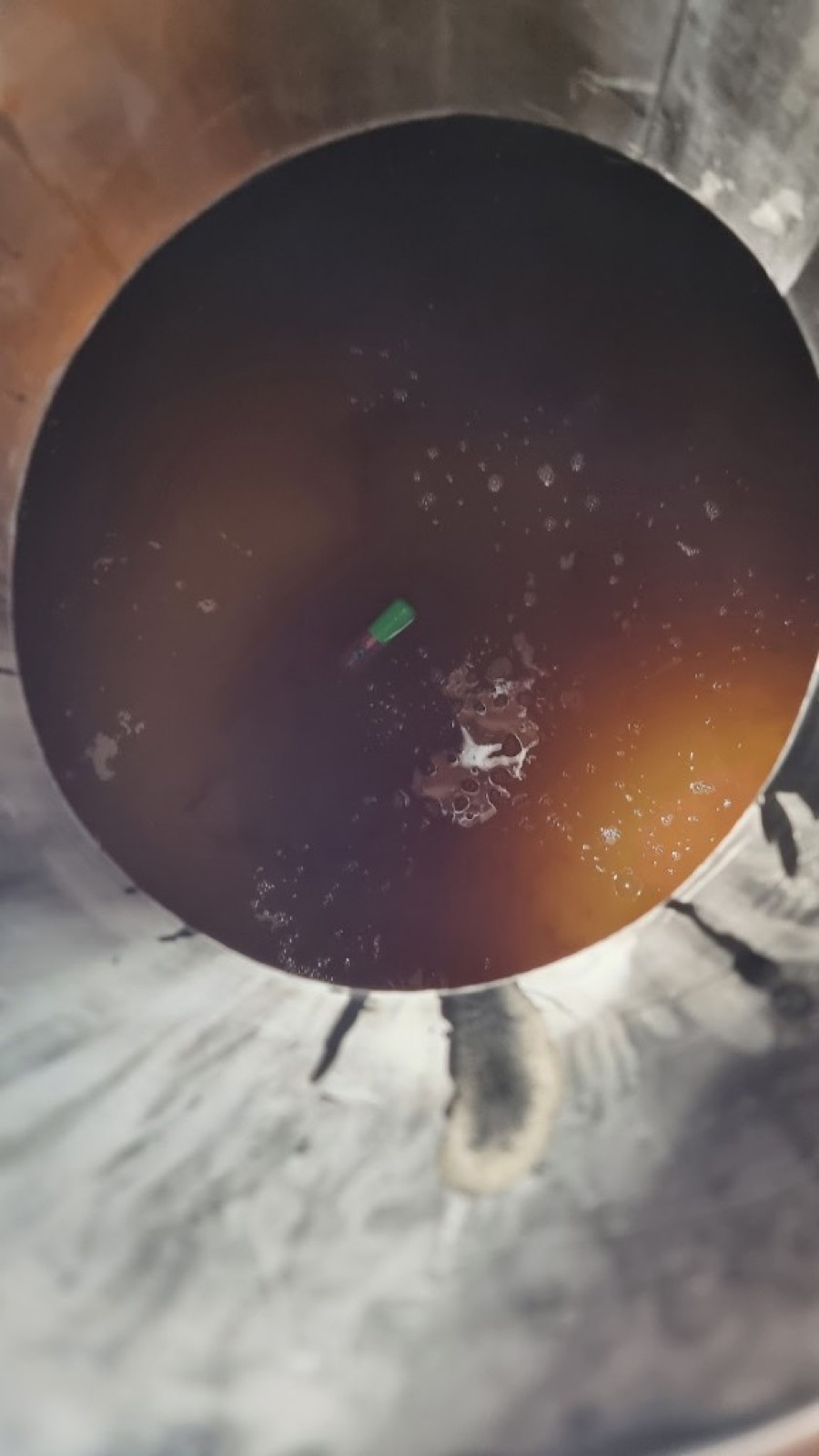 SCEPTER measuring float submerged in fermenting must inside a stainless steel tank